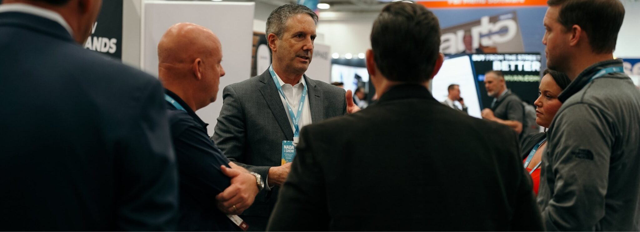 Glenn Pasch talking with a group of dealership leaders at the NADA Show