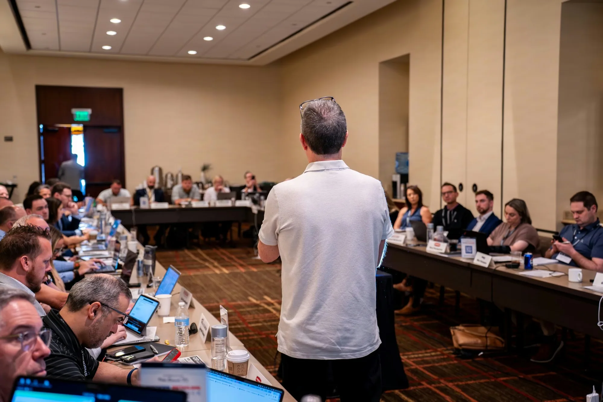 A CXO Summit working session, with dealer-group leaders around a U-shaped table